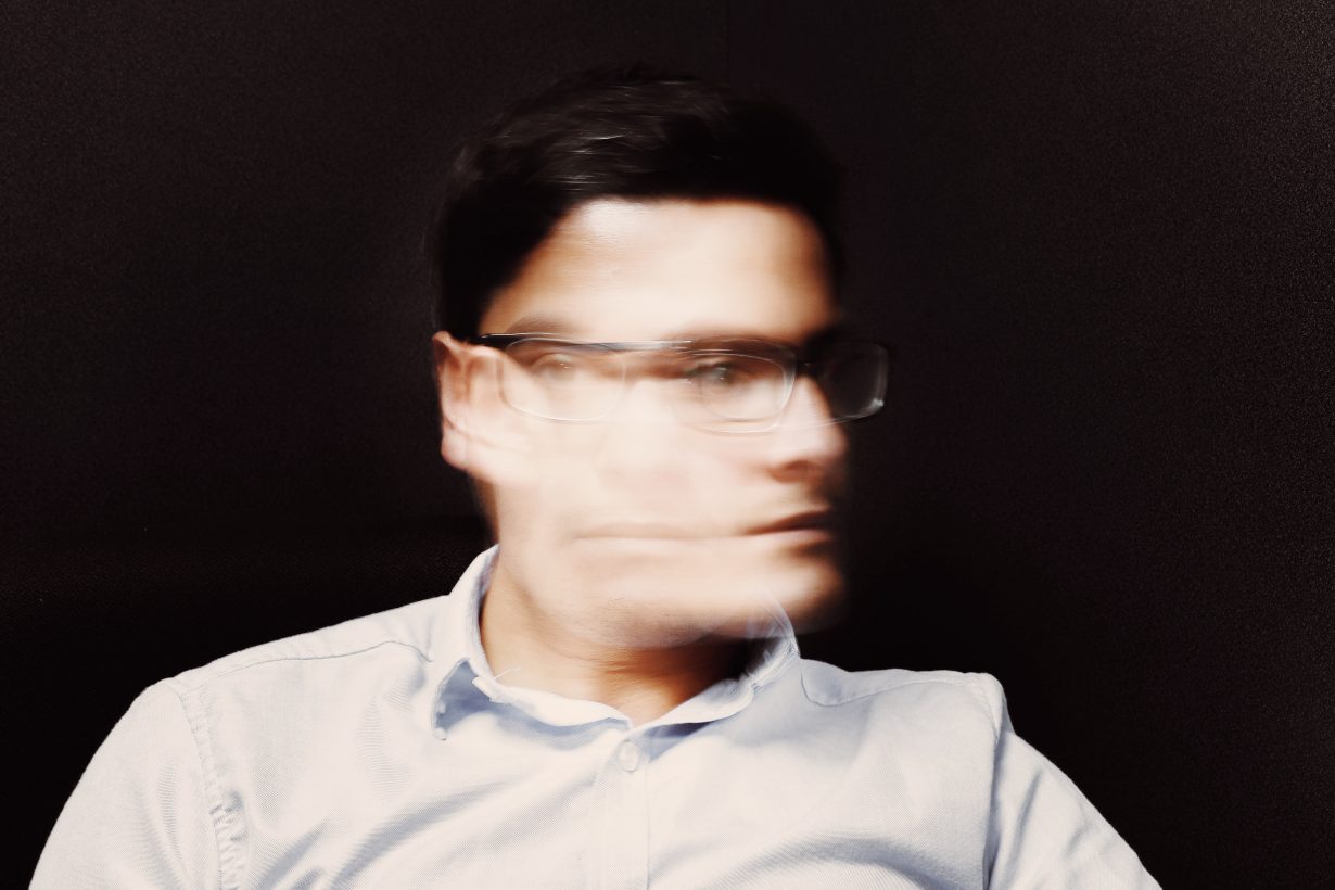blurred image of a man shaking his head