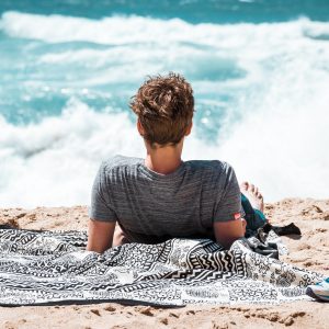 person lying on the beach in the sun