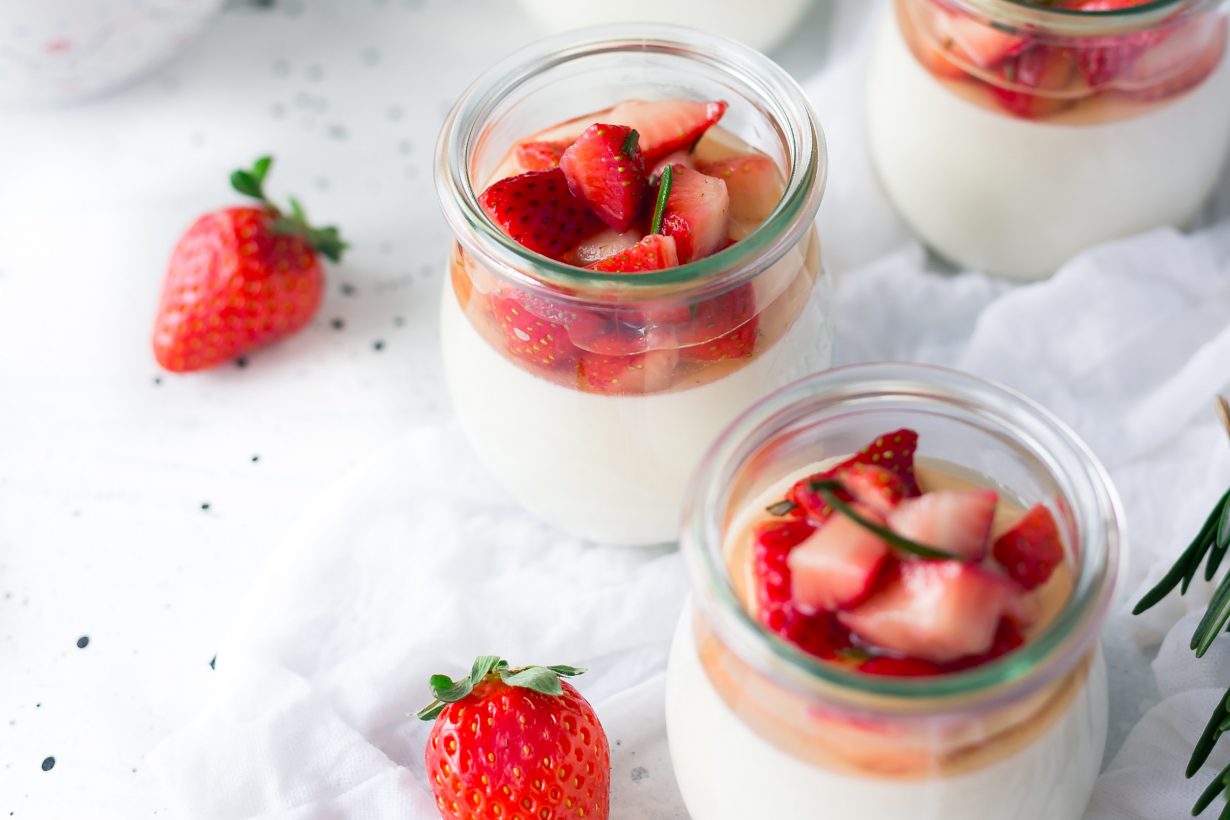 bowls of yogurts with strawberries on top