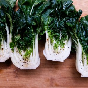 heads of bok choy on a cutting board