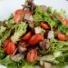 close up of a garden salad with meat and tomatoes