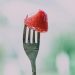 close up of a strawberry on a fork