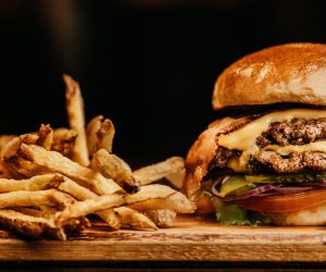 close up of double decker cheeseburger and french fries