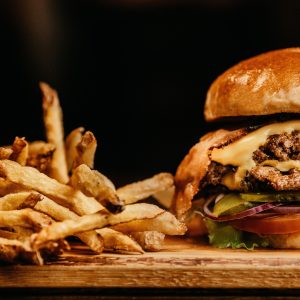close up of double decker cheeseburger and french fries