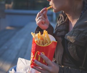 woman eating McDonald's french fries