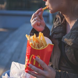 woman eating McDonald's french fries