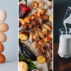 close up of eggs, grilled meats, and a glass of milk