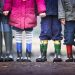image of the legs of 4 children wearing rain boots