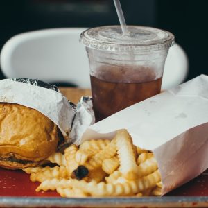 hamburger, french fries, soft drink on a table