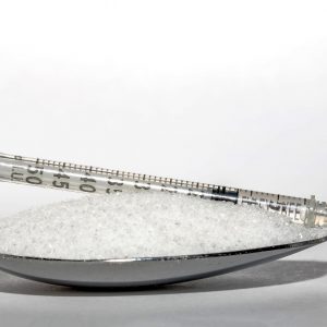 spoonful of sugar with an insulin syringe on top