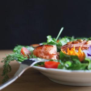 salmon fish on a leafy green salad