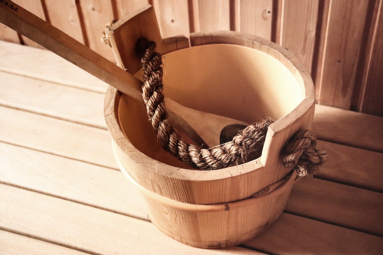 wooden spoon inside a wooden bucket