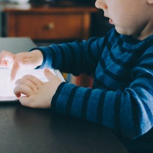 image of a child playing on an iPad