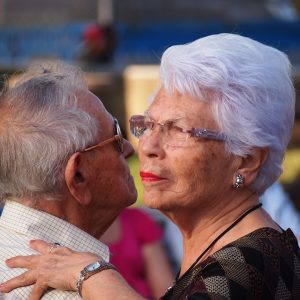 An older man and woman dancing together