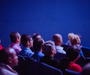 people watching a movie in a theater