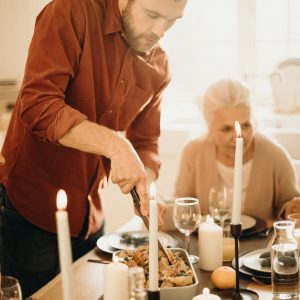 family at a dinner table celebrating holidays