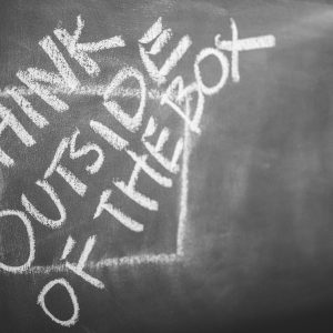 Think Outside the Box written outside the lines of a square on a chalk board