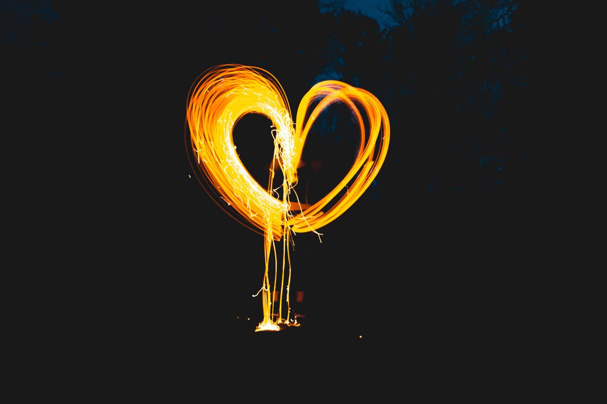 photo of a person making a heart out of a sparkler
