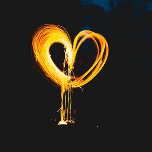 photo of a person making a heart out of a sparkler