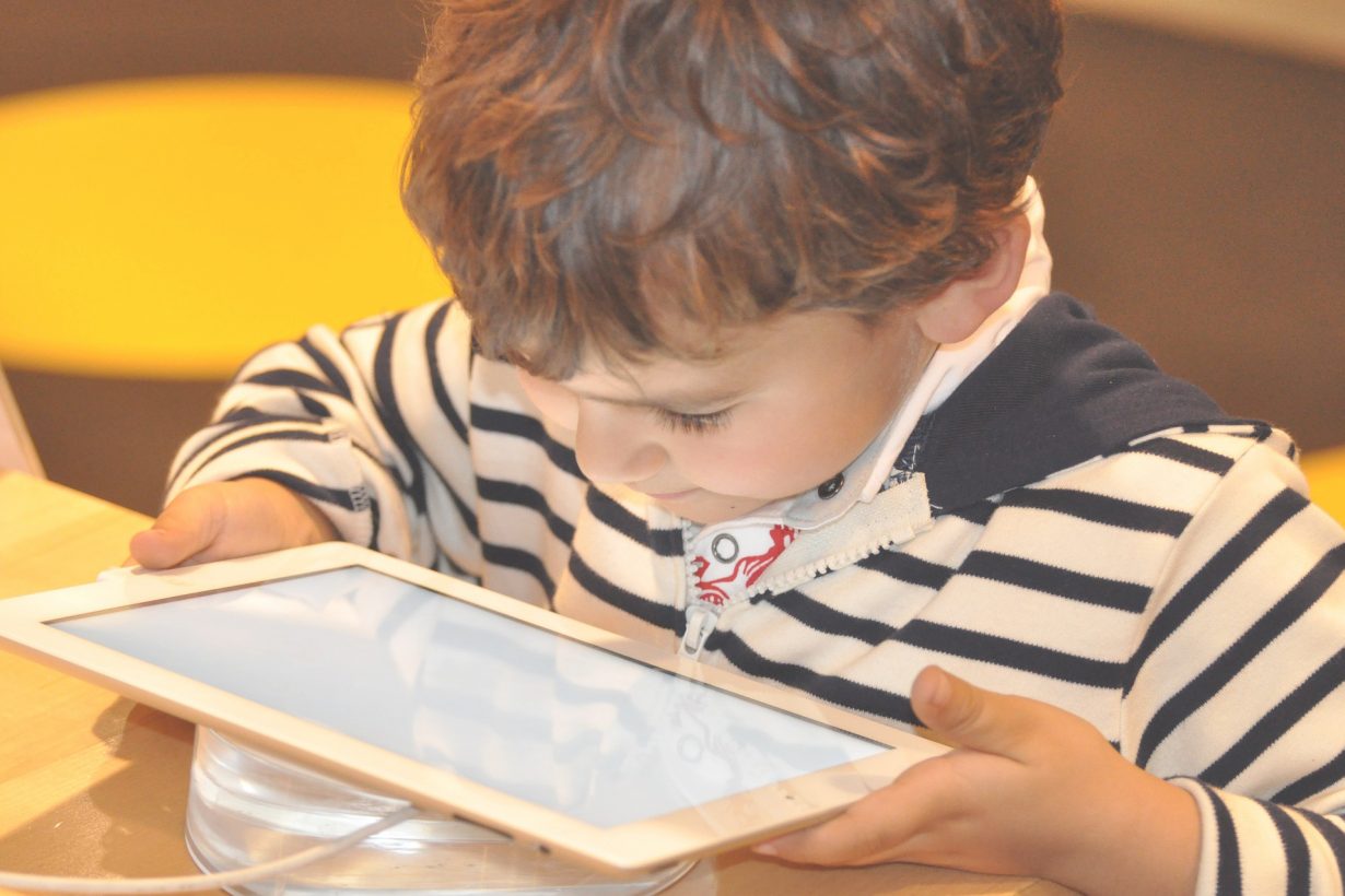 young child looking at a tablet device