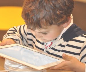 young child looking at a tablet device