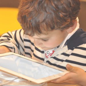 young child looking at a tablet device