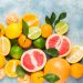 a punch of citrus fruits piled up on a blue background