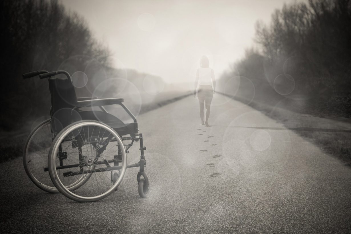 person walking away from a wheelchair