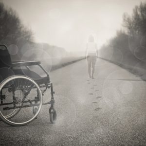 person walking away from a wheelchair