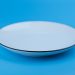 empty white plate on a blue background
