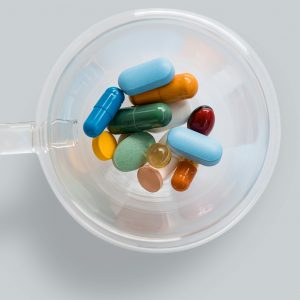 cup full of a bunch of medications
