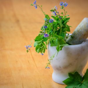 mortar and pestle with herbs inside