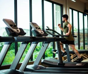 man running on a treadmill at a gym