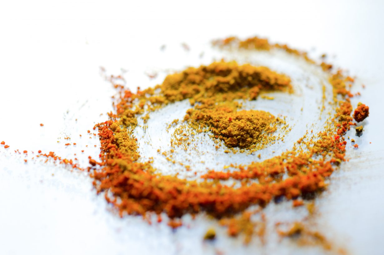 powdered turmeric on a white surface
