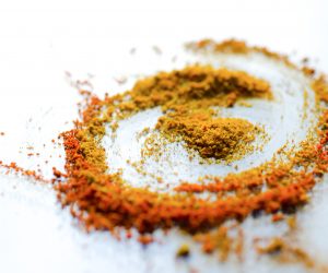 powdered turmeric on a white surface