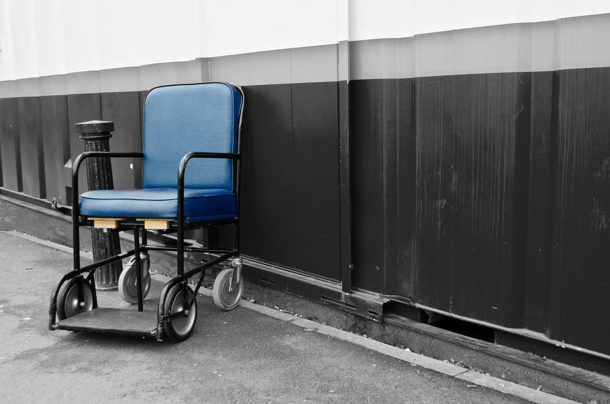empty electric wheelchair by a wall