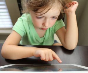 little girl looking at a tablet