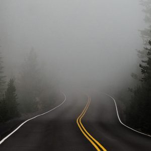 a road with fog in the distance