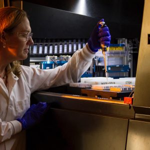 female lab researcher working in a lab