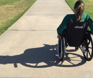 woman in wheelchair on a sidewalk