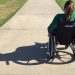 woman in wheelchair on a sidewalk