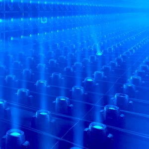 a bunch of blue lights lined up in a room