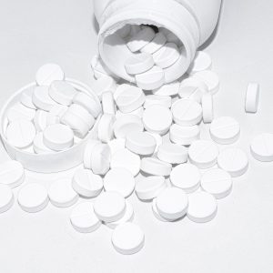 bottle with white magnesium tablets spilled out