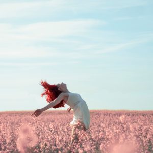 woman carefree in a field of flowers