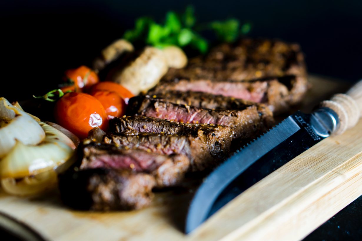 sliced up steak on a cutting board