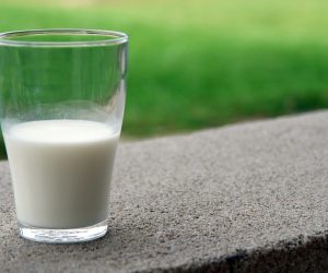 glass of milk on a concrete surface