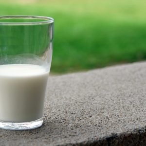 glass of milk on a concrete surface