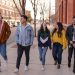 group of teenagers walking on a sidewalk