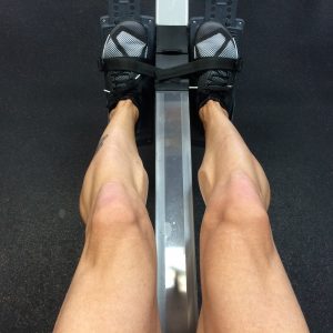 man's legs working out on a machine