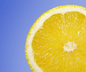 close up of a lemon on a blue background
